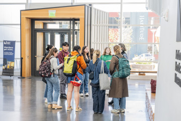 A group of people gathers in the lobby of the National Nordic Museum.