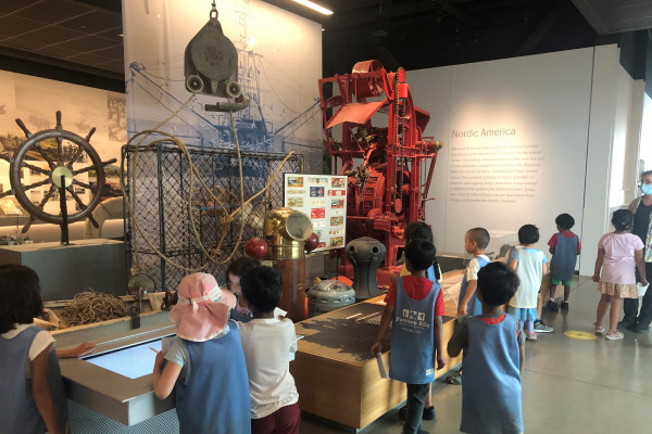 An elementary school group tours the "Nordic Journeys" exhibition.