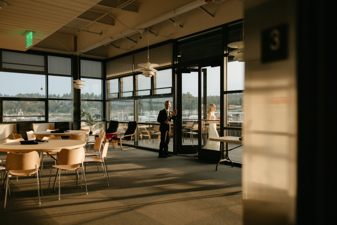 A couple walks onto the deck connected to the Nielsen Lounge at sunset.