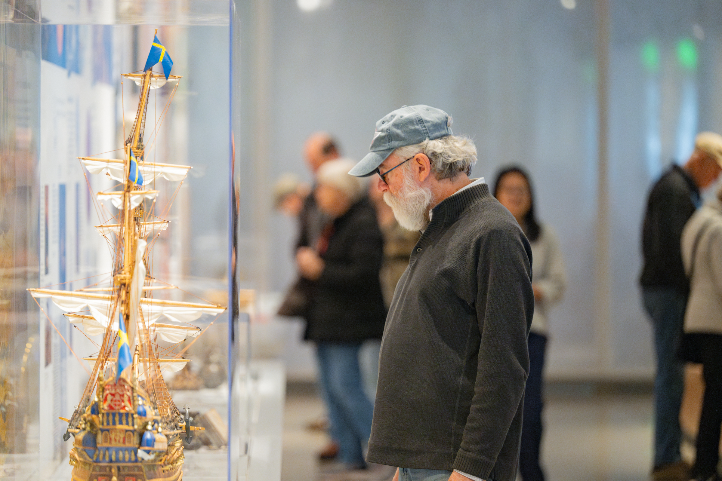 A visitor looks at a wooden model of a ship at the National Nordic Museum.